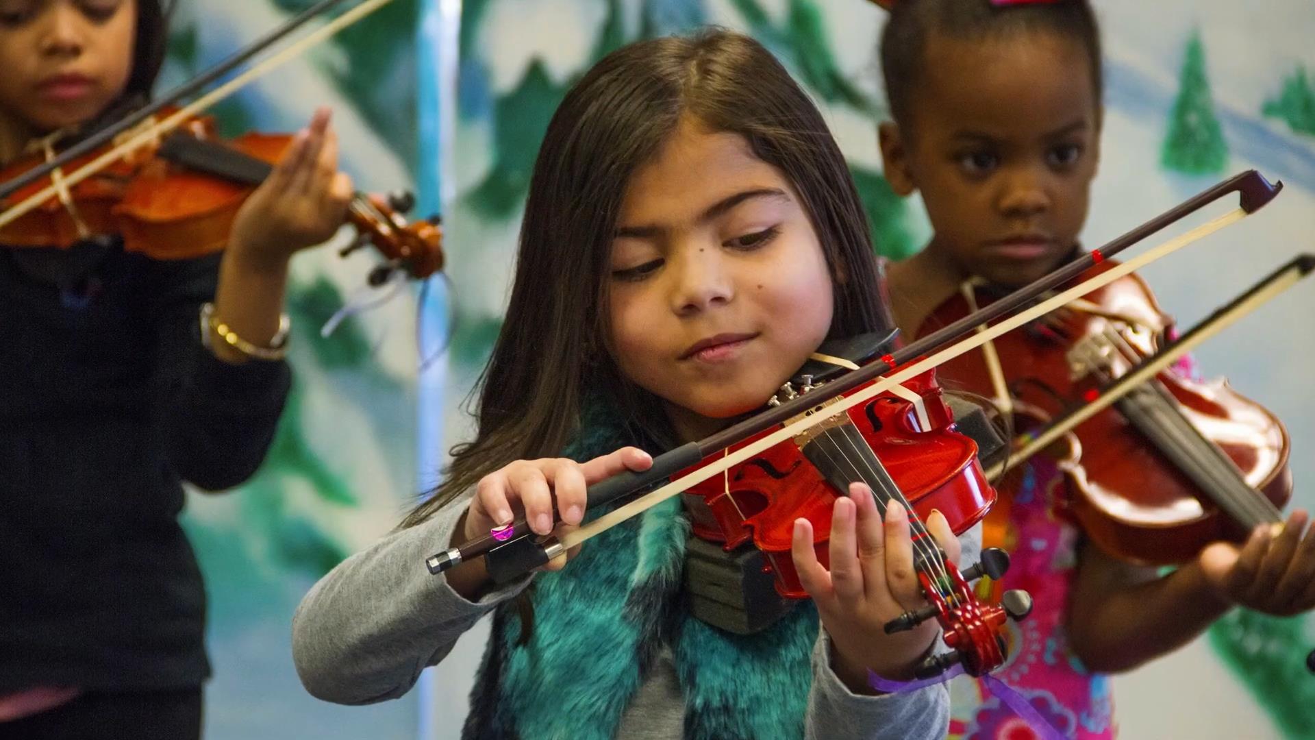 Young girl playing her violin